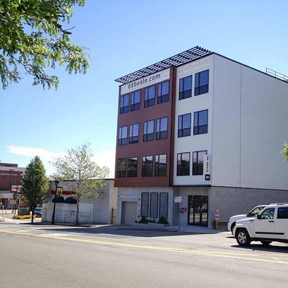 a white building with a red and brown sign on it.
